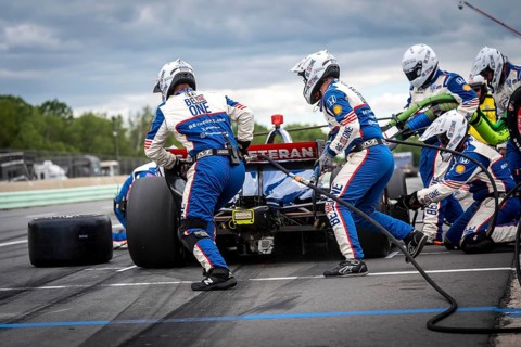 LINUS LUNDQVIST (R) (8) of Stockholm, Sweden comes down pit road for service during the XPEL Grand