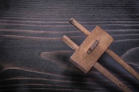 Vintage marking gage on wooden board construction concept