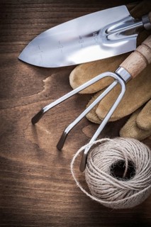 Metal hand spade rake pair of brown leather gardening gloves and hank of rope on vintage wooden