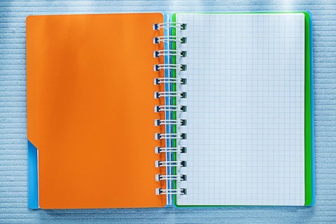 Spiral checked notebook directly above