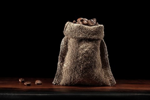 Classic Jute Bag Coffee Beans Standing On Wood Board Isolated