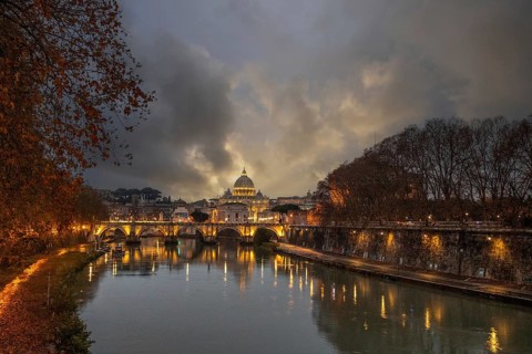 View over the river Tiber in a historic city. The old famous bridge Ponte Sant'Angelo, in the