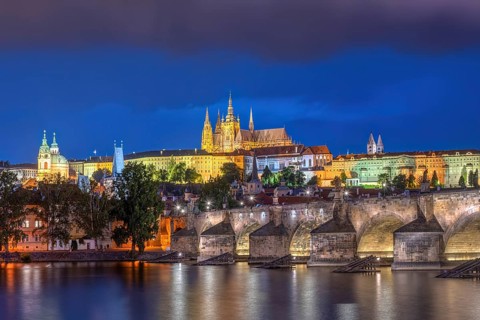 The imposing St Vitus Cathedral and Charles Bridge in Prague by night