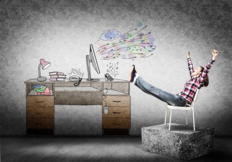 Young happy woman relaxing in room. Creative freelance designer sitting on chair and putting feets