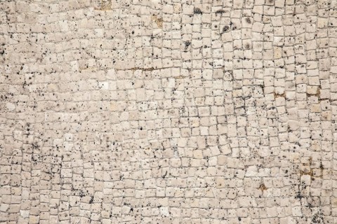 Mosaic floor as a texture of white little stones with dirt and crumbs