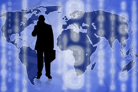 Illustration of a businessman on top of a world map