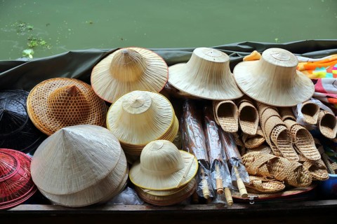 Boat with hats on floating market Damnoen Saduak in Bangkok, Thailand