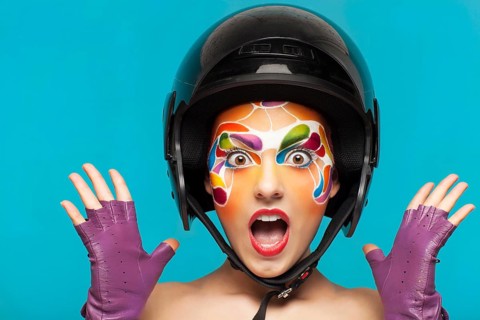 Portrait of a beautiful young model with bright creative make up with helmet