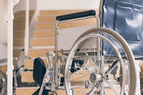 Empty wheelchair and stairs. Disabled accessibility reality