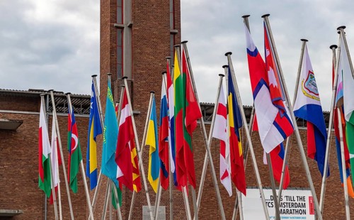 A picture of many country flags in front of the Olympic Stadium as part of the 2022 edition of the