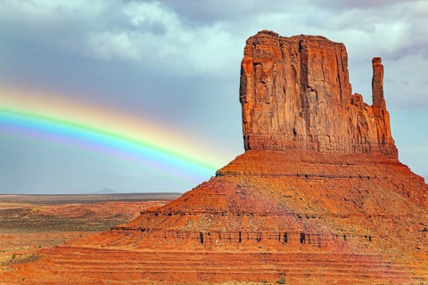 The famous rock Mittens and the bright rainbow. USA. Navajo Indian Reservations. Monument Valley is