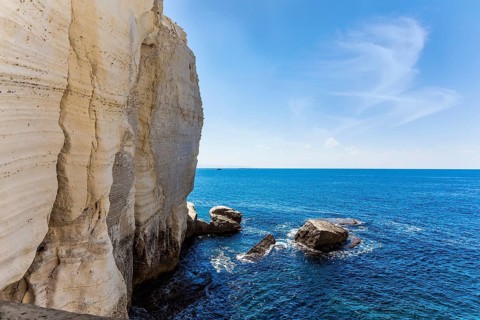 Israel. The color of sea water changes from azure to dark blue. Karst cave Rosh-a-Nikra on the