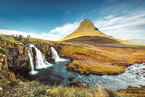 Landscape view of Kirkjufellsfoss In the daytime, blue sky and beautiful clouds. The waterfall is