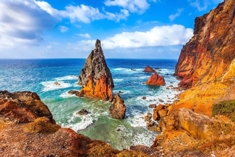 The blinding midday sun illuminates the rocky shore. Madeira is a magical island in the Atlantic.