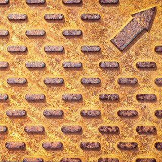 Steel rusty texture from Manhole cover. Orange metallic background