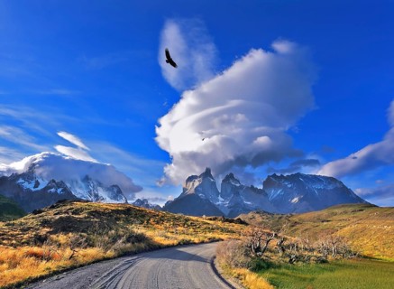 National Park Torres del Paine in southern Chile. A dirt road leads to the distant mountains. A