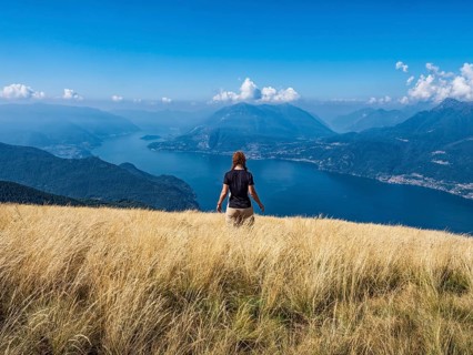 Woman walking in a prairie on Lake Como alps