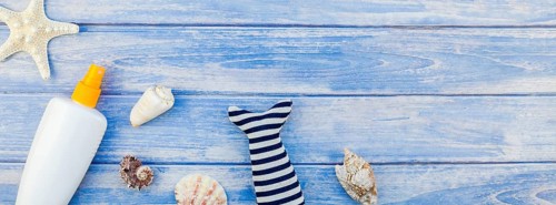 Long wide banner flat lay concept summer travel vacations. Top view of sunscreen bottle mockup