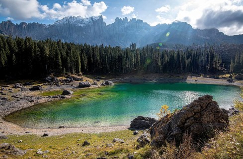 Lake Carezza or Karersee lake with deep blue colored water and the dolomite mountain range Trentino