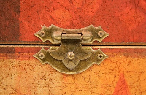 An old tarnished clasp fastening a lid to a box