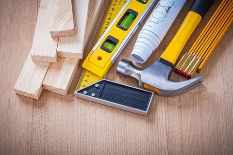 Group of house-improvement working tools on wooden board building and architecture concept