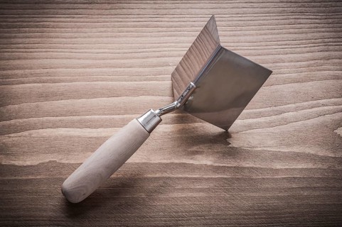 Hand angle former with wooden handle on wood board