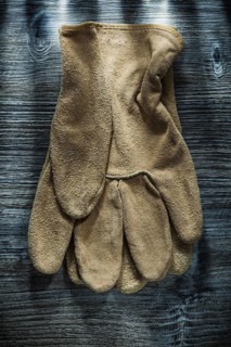 Safety gloves on wooden board