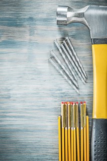 Claw hammer nails wooden meter on wood board construction concept