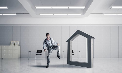 Determined businessman going to break with kick house concrete figure