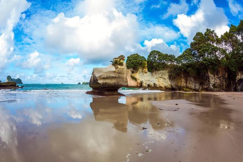 Cathedral Cave on the North Island of New Zealand. Coromandel Peninsula. Bizarre clouds and coastal