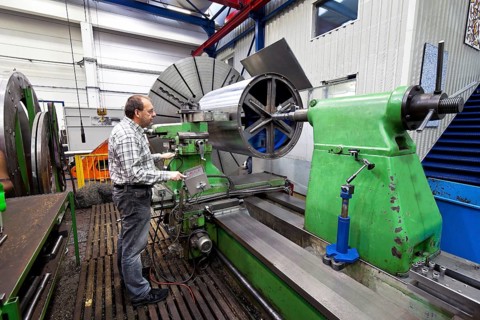 An older worker in the metal industry at a CNC milling machine, Austria