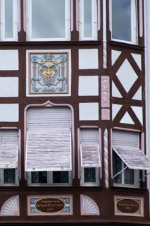 An old listed residential and commercial building of a former pharmacy with the coat of arms of the