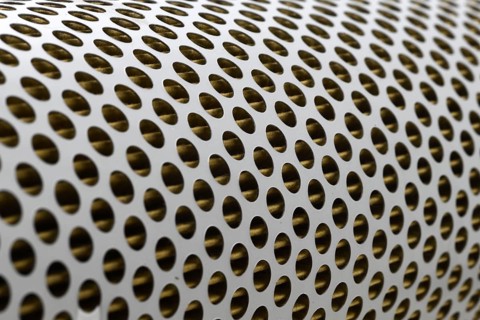Detail of a tractor oil filter creates an industrial textured background
