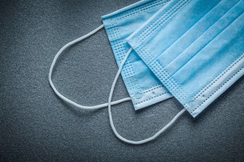 Surgical masks on grey background