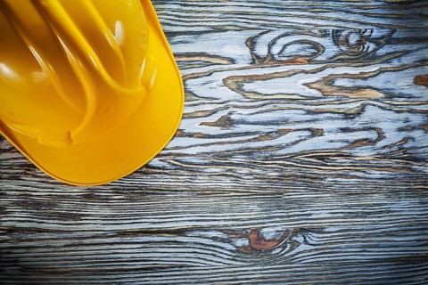 Safety hard hat on vintage wooden board