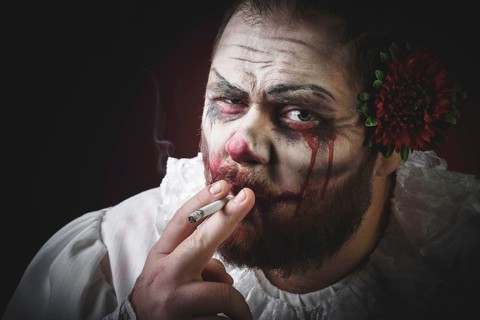 Portrait of a Scary Evil Clown. Studio shot with horrible face art