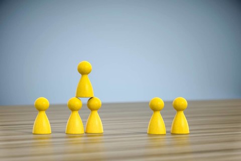 3d illustration of some game figures building a pyramid