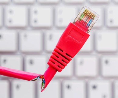 Defective network cable on keyboard, symbolic photo for online, networks, interference and