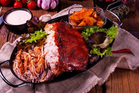 Delicious pulled pork with jacket potato quarters