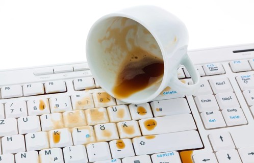 Coffee cup spilled on a computer keyboard. Damage for insurance company. Austria