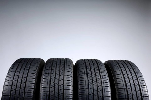 Set of all-season tires isolated on gray background