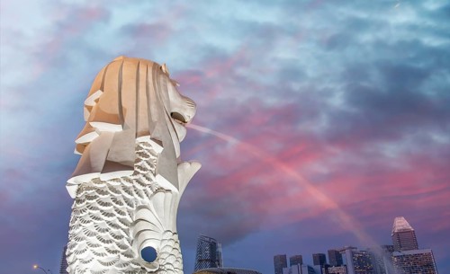 The Merlion of Singapore and the city skyline at sunset