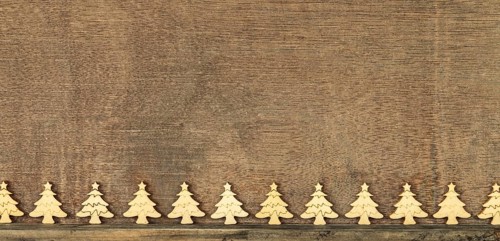 Christmas decoration wooden background with row of small wooden fir trees