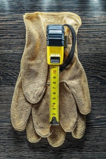 Tapeline safety gloves on wooden board