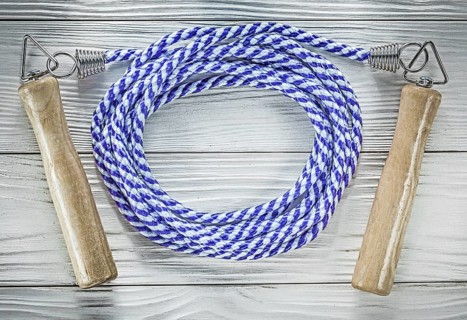 Rolled skipping rope on wooden board sports training concept