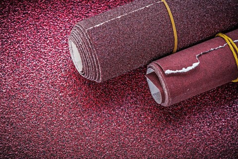 Rolls of polishing paper on abrasive sheet construction concept