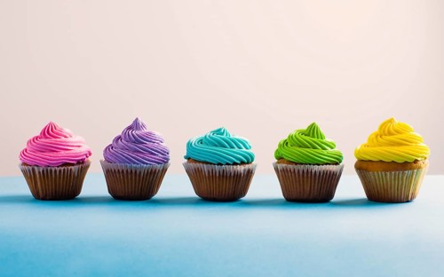 Vivid colous cupcake in a row. Different choices during the life