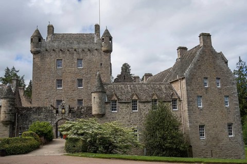 A medieval castle with impressive stone walls and towers, surrounded by trees, inverness, scotland,