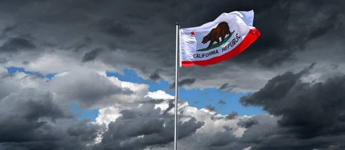 Dramatic sky with national flag of California in strong wind