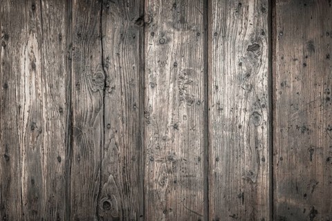 Rough wooden planks, dark and deteriorated by time